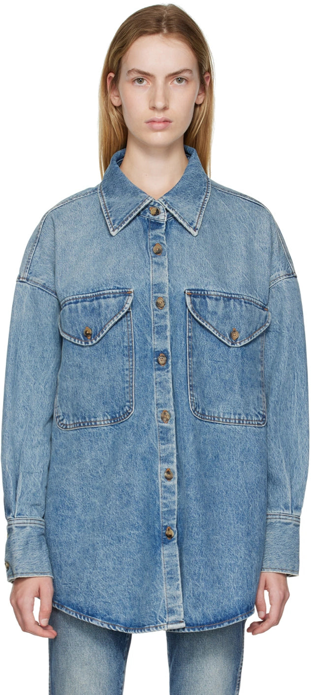 Take risks and make a statement with The Birdie Denim Shirt from KHAITE. Crafted from non-stretch denim with fading throughout, this shirt features a spread collar, button closure, and flap pockets for a touch of adventure. With a shirttail hem, dropped shoulders, and tortoiseshell hardware, this 100% cotton shirt is perfect for those who aren't afraid to stand out.