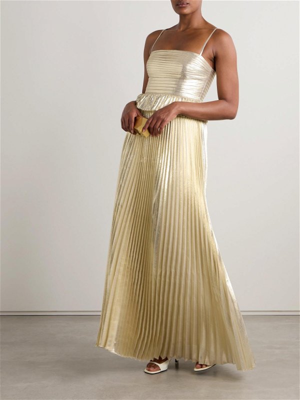 Indulge in the luxurious and mesmerizing Pintucked Plissé-Lamé Gown. Crafted from shimmering gold plissé-lamé, its pintucked bodice and ruffled peplum hem highlight your waist while providing a comfortable and secure fit. Perfect for any special occasion, this gown exudes elegance and sophistication. Elevate your look and make a statement as a bridesmaid or the woman-of-the-hour.