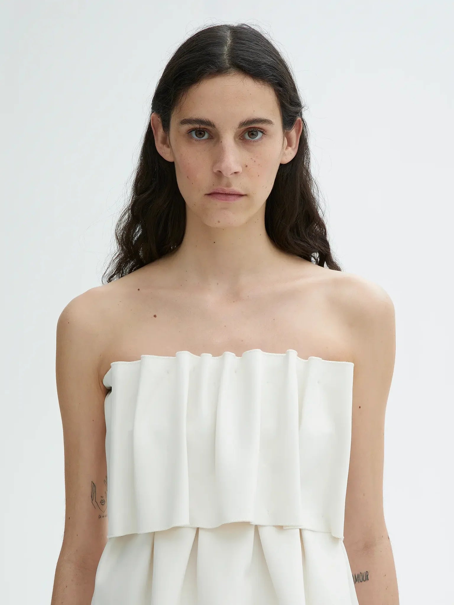 Introducing the Sculpted Tube Top by House of Dagmar - the perfect blend of elegance and sustainability! This sleeveless top features a sculpted, figure-hugging fit and a draped design, making it the ideal choice for dressier occasions. Add a touch of style and conscience to your wardrobe with this must-have top.