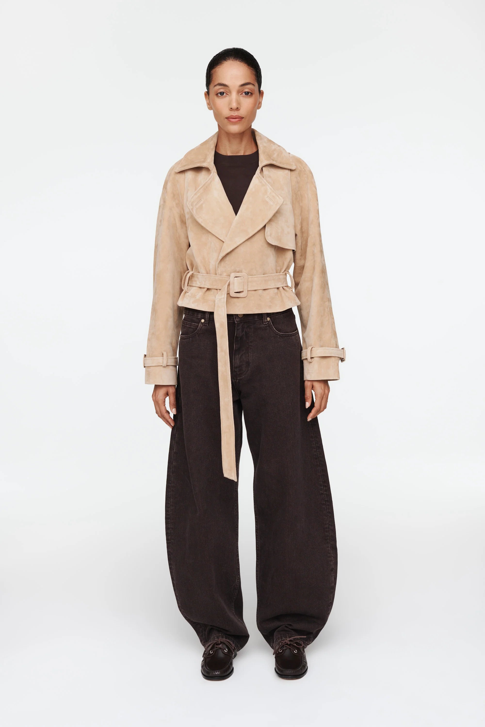 The Millie Suede Jacket by Ducie reimagines the classic trench with modern flair. This cropped silhouette features an oversized collar that commands attention, while adjustable belts at the hem and sleeves offer customizable styling and a polished finish. Effortlessly versatile, it's the ideal layer for elevating your spring and summer wardrobe with contemporary edge and timeless sophistication.