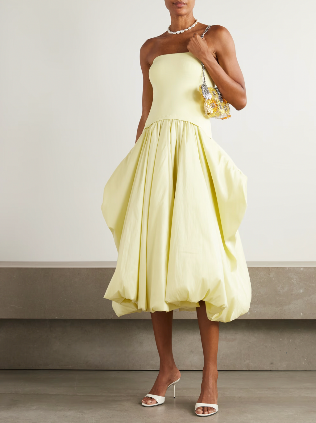 Experience elegance with SIMKHAI’s Izzy Stretch-knit and Gathered Taffeta Midi Dress. Featuring a fitted stretch-knit bodice and a voluminous taffeta skirt in a radiant Sunglow yellow, this strapless design sculpts your silhouette with a gathered waist and an eye-catching asymmetric bubble hem. Perfectly balanced and uniquely stylish, it’s an unforgettable choice for making a bold, sophisticated statement.