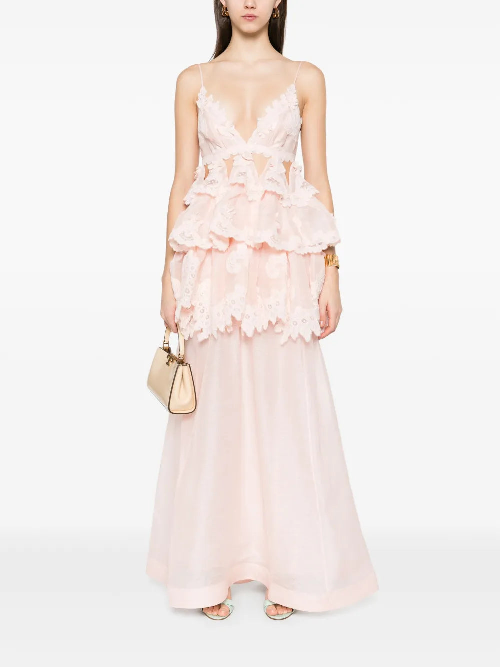 Elevate your style with the Zimmermann Tiered Lace Maxi Dress in delicate light pink. Featuring adjustable spaghetti straps and a flattering V-neck, this dress offers a perfect blend of comfort and elegance. The tiered lace design adds romantic texture, while the rear zip and clasp ensure a secure, tailored fit. Ideal for special occasions, it effortlessly combines sophistication with feminine charm.