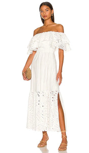 Get ready to show off your fun and flirty side with the Isabella Maxi Dress from Charo Ruiz! Made from a delicate broderie anglaise cotton-blend, this off-the-shoulder dress features tiered layers for added movement and style. Perfect for any occasion, this midi dress will have you feeling confident and fabulous.