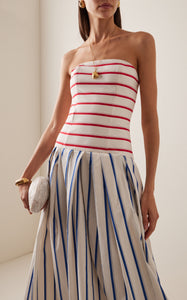 This strapless striped cotton gown by Rosie Assoulin features a sophisticated drop-waist silhouette that flatters the figure while offering comfort. Crafted from breathable cotton, its clean lines and bold stripes create a modern yet timeless look, ideal for elegant occasions where effortless style is paramount.
