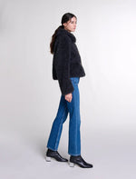 Load image into Gallery viewer, Indulge in the timeless elegance of Parisian style with the Curly Coat by Maje. This winter, our ode to sophistication and boldness features a short, textured coat adorned with golden accents. Stay warm and stylish with the wide collar, lined interior, and ribbed pockets. Perfect for a chic and casual look with a top, jeans, and booties.
