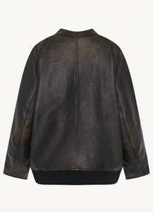 The Row brown oversized motorcycle jacket in distressed calfskin leather with stand collar, raglan sleeves, side welt pockets, and ribbed hem. Finished with silver-toned front and interior cuff zippers. This jacket comes fully lined in silk Habotai.