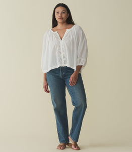 Crafted from a 100% organic cotton voile, the Abigail Top features a breezy silhouette, a round neckline, and buttons running down the center front. Billowy sleeves trimmed with scalloped lace hit just above the wrist, while alternating pintuck clusters, lace, and delicate floral embroidery decorate the front. Leave it loose, or tuck it into your favorite pair of high-waisted jeans.