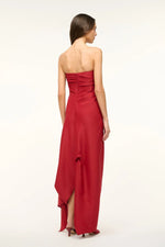 Load image into Gallery viewer, Unleash your daring side with the Caravaggio Dress Rouge by STAUD! This luxurious maxi dress, crafted from a silk wool blend, drapes elegantly and offers structural support with its built-in corset. Perfect for any adventure, this dress combines ease and sophistication. Embrace the challenge and stand out in style!
