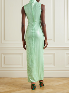 This maxi dress is perfect for any event. Its sequined fabric gives it a stunning shine, while its recycled-tulle material promotes sustainability. The high neckline and fluid silhouette add elegance, and the fresh mint shade adds a touch of uniqueness. Pair with drop earrings for a complete look.