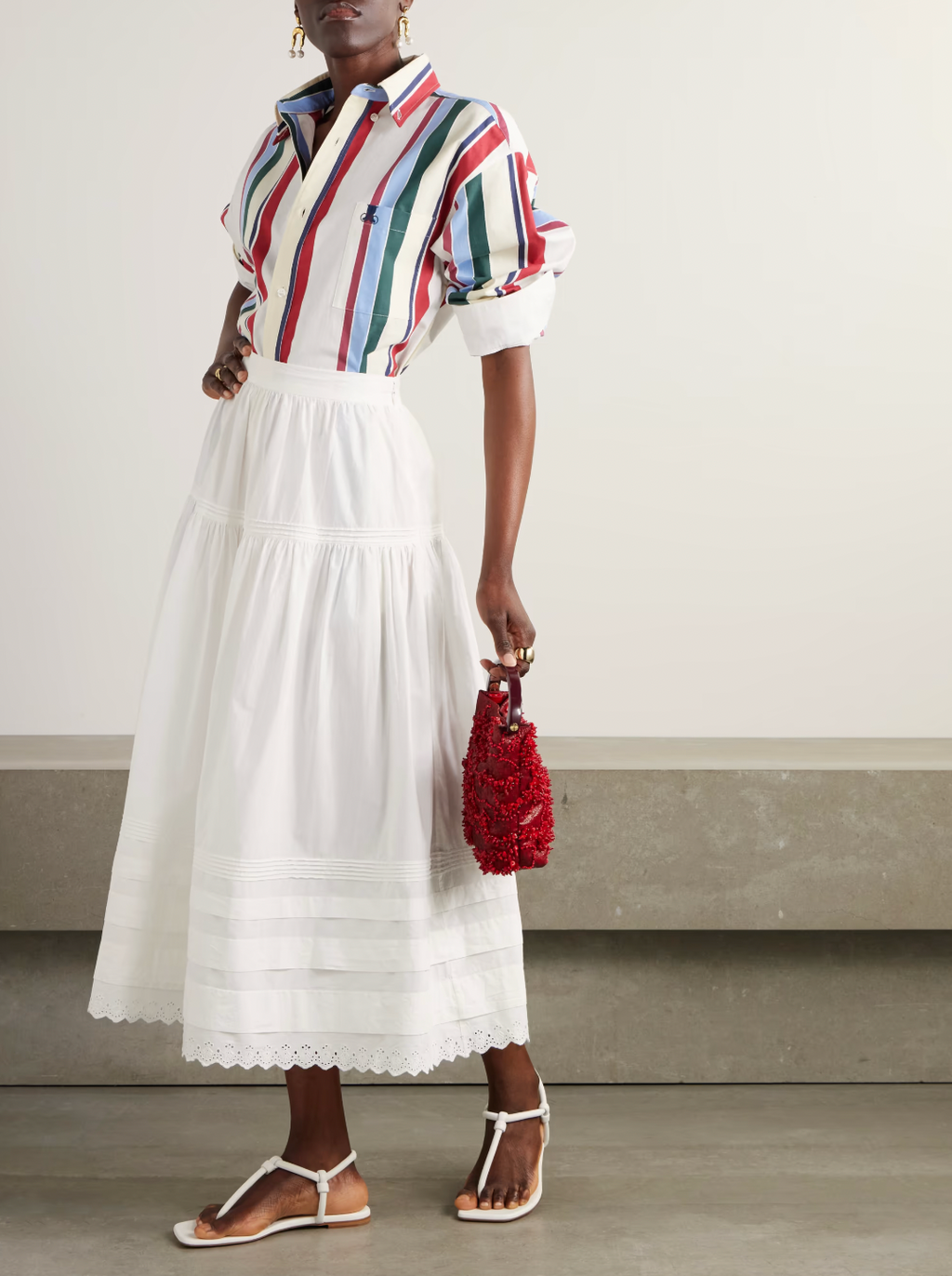 Inspired by Edwardian bridal tradition, this Sebastiane skirt combines timeless elegance with modern sustainability. Crafted from organic cotton-poplin, its tiered silhouette features delicate pintucks and elegant broderie anglaise trim, adding a touch of vintage charm to your wardrobe. Perfect for those who appreciate refined detail and eco-conscious fashion.