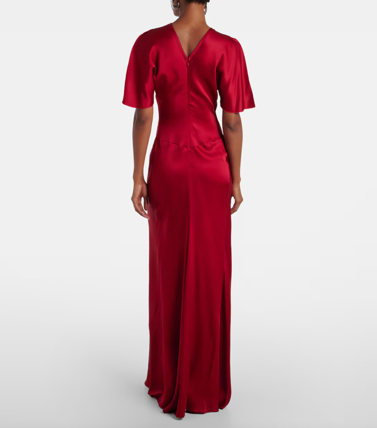 Stunning in vibrant red crêpe satin, this Victoria Beckham gown masterfully balances elegance with edge. Dramatic cape shoulders provide modest coverage while the daring open back commands attention—a sophisticated contrast that turns heads. Expertly gathered detailing sculpts a flattering hourglass silhouette, making this the perfect statement piece for unforgettable evenings. Timeless design meets modern allure.