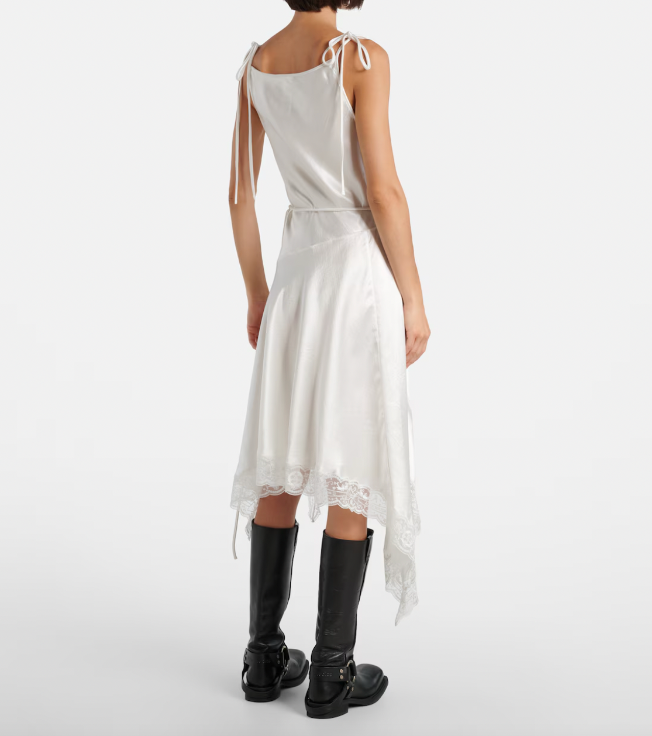 Embrace understated elegance with this satin minidress from Stockholm’s Acne Studios. Its smooth fabric skims the body while delicate lace trims add a feminine touch to the asymmetric hem, creating a modern yet romantic silhouette. Perfect for making a subtle statement, this dress effortlessly blends Scandinavian cool with alluring detail.