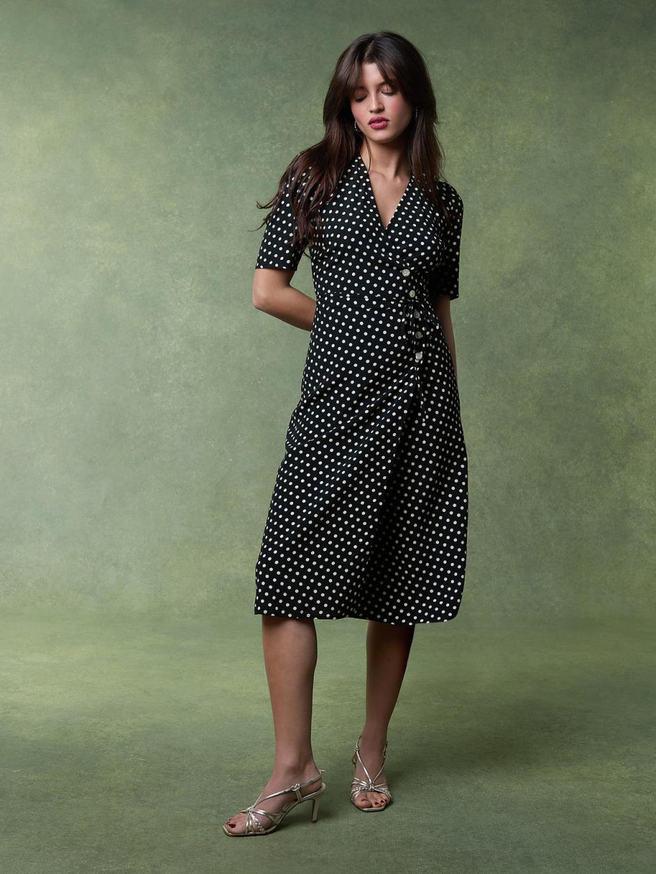 Feel effortlessly chic and sophisticated in our Carmen Midi Dress. The black and white weight print adds a touch of elegance while the V neckline and five button and tie fastening on the front create a flattering silhouette. The lined skirt ensures comfort and poise. Perfect for any occasion.