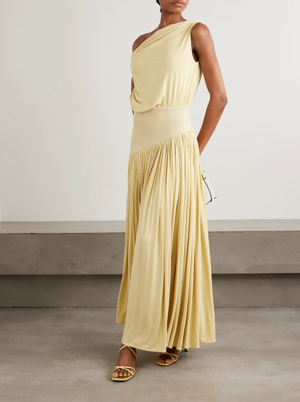 Discover effortless elegance with the Gwen Asymmetric Draped Jersey Dress by Abadia. Crafted from luxuriously soft stretch-bamboo fabric, this stunning piece features a sophisticated one-shoulder design that flatters every frame. Artfully draped details flow gracefully from the fitted top through the skirt, creating a silhouette that's both modern and timelessly chic. 