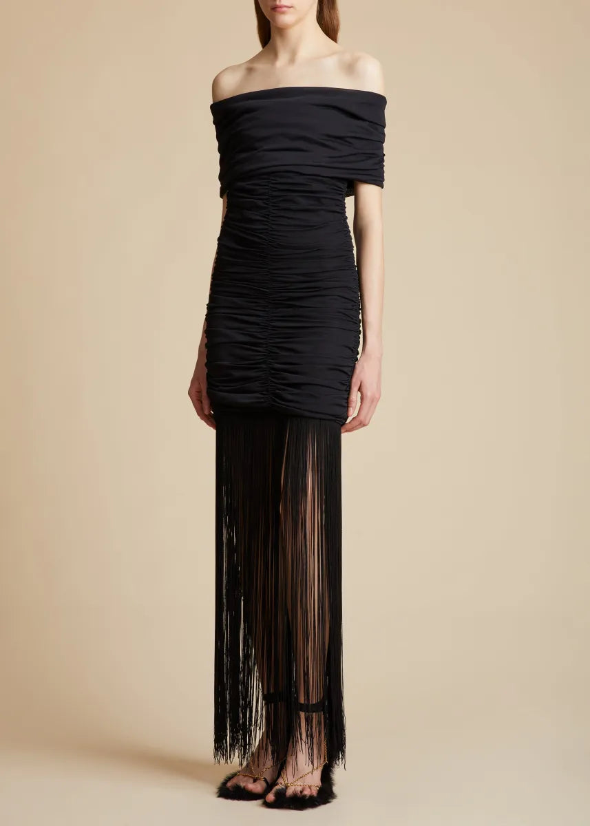 Introducing the Jacinta Dress in Black by Khaite, the epitome of elegance and contemporary flair. From the Pre-Fall collection, this off-the-shoulder knit dress is crafted from fine crepe viscose for a sleek silhouette. The enticing draping and rich texture, along with playful fringe detailing, make this piece perfect for any evening event or chic gathering. With no closures, it offers effortless wear and a close fit, elevating any occasion.