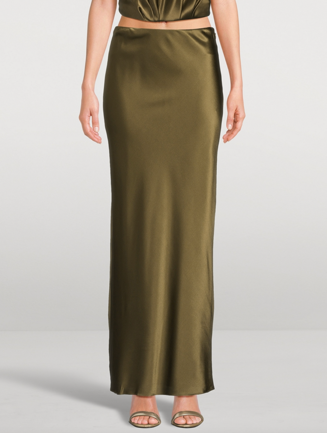 Experience effortless elegance with the Chantel Satin Slip Skirt by Cult Gaia. Cut on the bias for a flattering fit, this maxi-length piece is crafted from glossy silk that gently stretches for comfort. Its smooth, flowing silhouette enhances every movement, making it perfect for both day and evening wear. Elevate your wardrobe with this timeless, luxurious skirt that exudes sophistication and versatility.