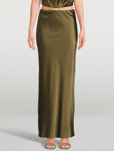 Experience effortless elegance with the Chantel Satin Slip Skirt by Cult Gaia. Cut on the bias for a flattering fit, this maxi-length piece is crafted from glossy silk that gently stretches for comfort. Its smooth, flowing silhouette enhances every movement, making it perfect for both day and evening wear. Elevate your wardrobe with this timeless, luxurious skirt that exudes sophistication and versatility.