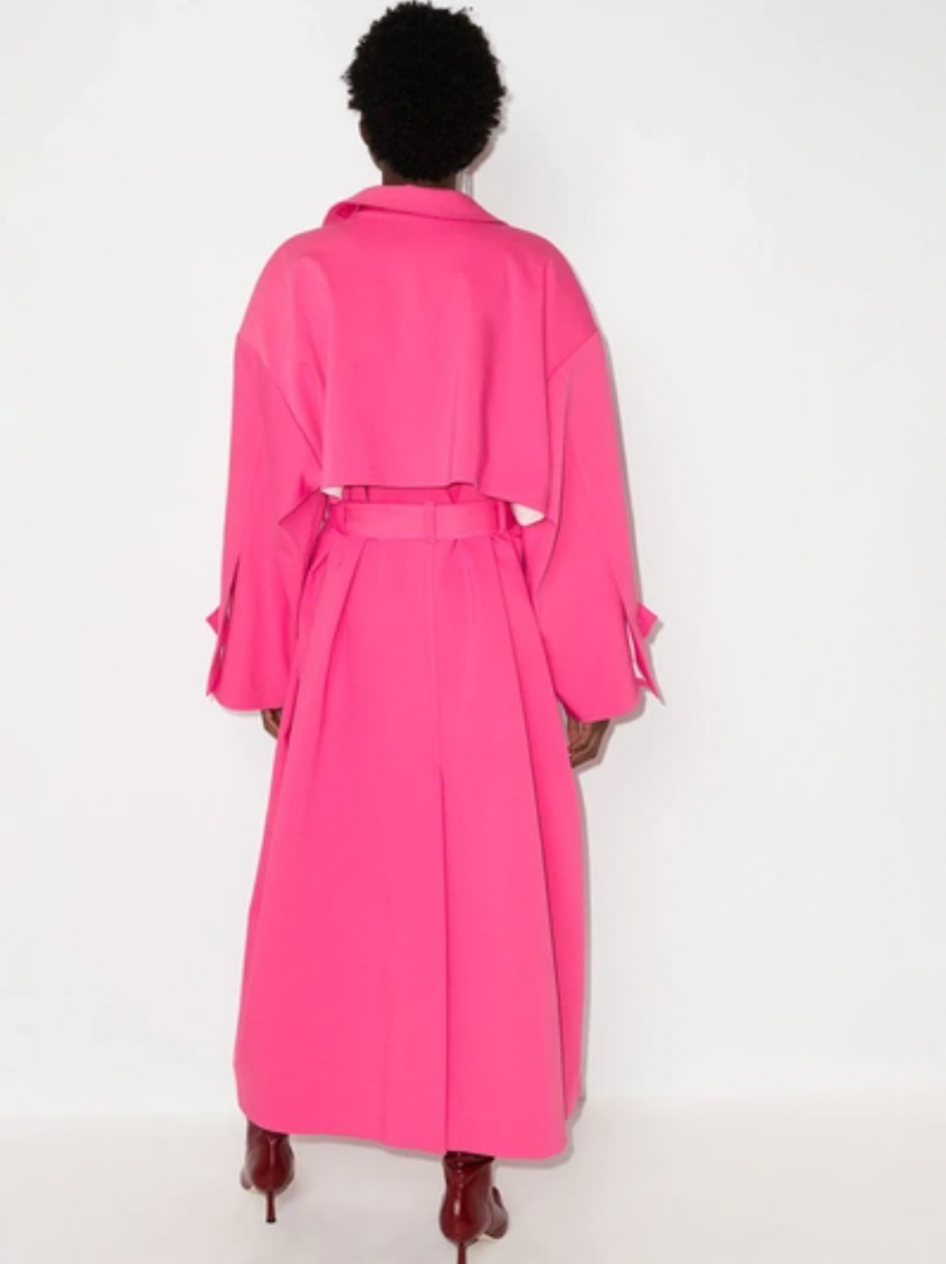 This pink ANOUKI oversized belted trench coat is designed with a wrap silhouette. Boasting a sparkling A logo to the buttoned cuff tab, it features large notched lapels, dropped shoulders, long sleeves, a back storm flap and centre vent, slip side pockets, belt loops and a self-fabric tie belt. Project Runway taught us how to 'make it work,' now flaunt what ANOUKI made you and say Auf Wiedersehen to the other coat-estants.