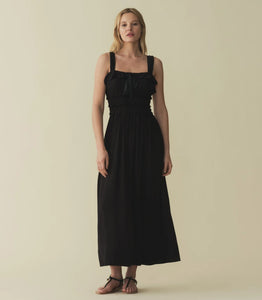 The Carolynn Dress—in a lightweight blend of rayon and viscose—features a square neckline, a gathered bust, and a fitted bodice framed with petite ruffles. Elastic lends give to the bust and waist, giving way to a swingy, ankle-length skirt.