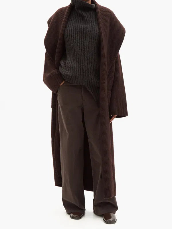 Embrace statement style with The Row's Daelan cardigan. Made from 100% wool, this dark brown longline cardigan features ample shawl lapels and patch pockets for a timeless yet bold look. Designed in Italy, it's perfect for the risk-taker who wants to make a statement.