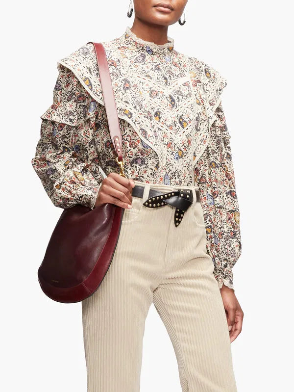 Step into the free-spirited 70s with the Reign Ruffled Paisley-Print Blouse! Adopted by icons like Janis Joplin and Jimi Hendrix, this Isabel Marant Étoile blouse exudes bohemian charm with its multicoloured paisley pattern. Lightweight poplin and delicate lace-trimmed ruffles add a feminine touch. Pair with tailored trousers for a stylish contrast.