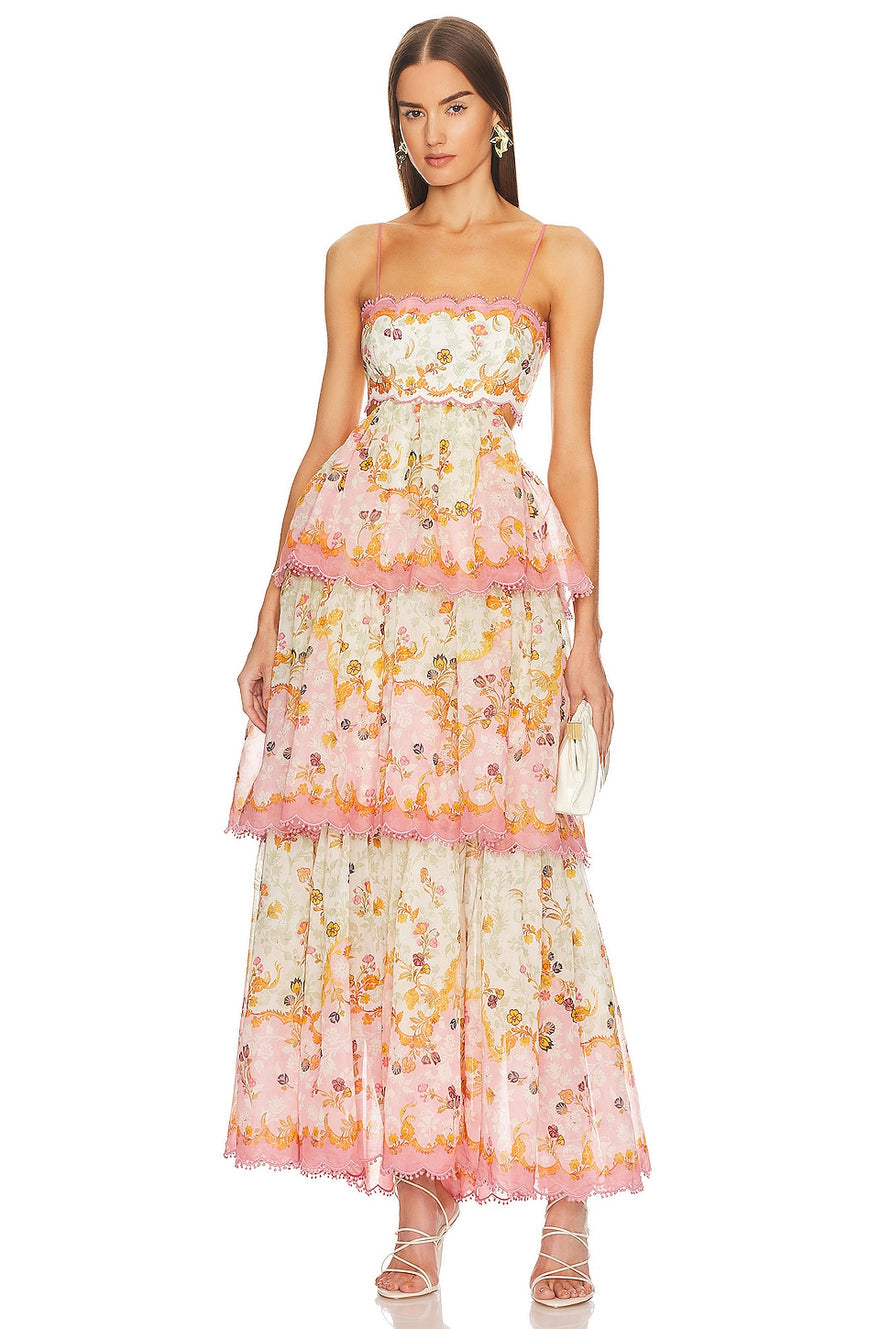 The Laurel Frill Gown is a stunning choice for any special occasion. Its straight neckline with scallop cut detail and tiered frill skirt add a touch of femininity and fun. The lace-up corset back is adjustable for a comfortable fit on various body shapes. Perfect for weddings, baby showers, and garden events.