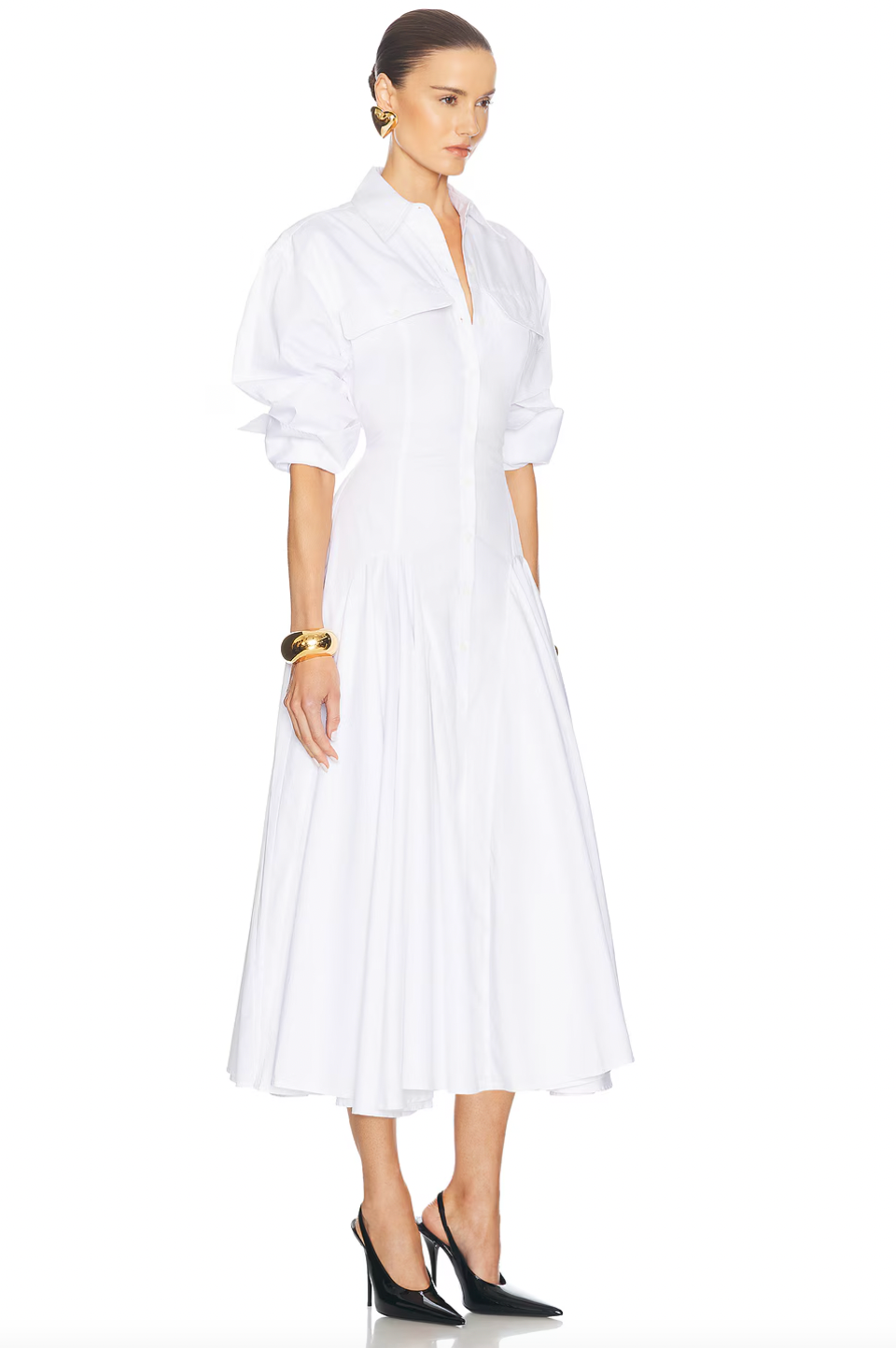 Elevate your style with the luxurious Godet Shirt Dress by Helsa. Made from premium poplin, this partially lined dress boasts a flattering fit and flare silhouette. With buttoned cuffs, front button closure, and flap pockets, it's a sophisticated and elegant must-have for your wardrobe.