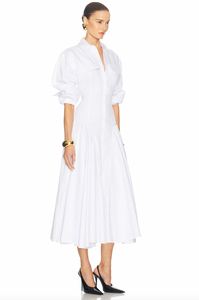 Elevate your style with the luxurious Godet Shirt Dress by Helsa. Made from premium poplin, this partially lined dress boasts a flattering fit and flare silhouette. With buttoned cuffs, front button closure, and flap pockets, it's a sophisticated and elegant must-have for your wardrobe.