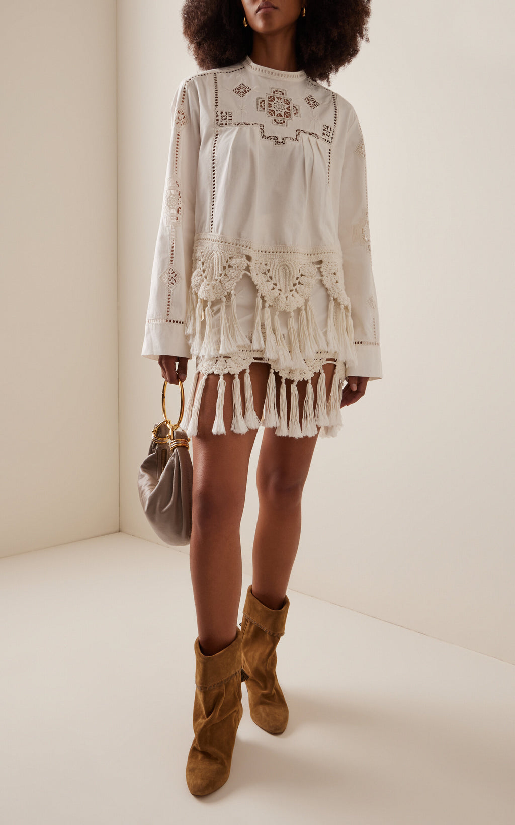 The Sanda Macrame-Trimmed Cotton Mini Skirt by Isabel Marant combines breathable cotton fabric with delicate embroidery and intricate macrame yarn tassels, offering both comfort and a refined artisanal touch. Ideal for warm weather, this skirt blends natural materials and expert craftsmanship to elevate your casual wardrobe with unique texture and style.