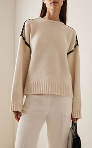 Embrace effortless Scandinavian style with this white wool-cashmere sweater by Totême. Crafted in a wide silhouette from mid-weight wool blended with cashmere, it offers cozy warmth and a soft touch. Intricate contrasting embroidery along the shoulders and armholes adds a refined, artisanal detail, elevating your everyday knitwear with subtle sophistication. Perfect for those who appreciate modern minimalism infused with a unique, handcrafted feel.