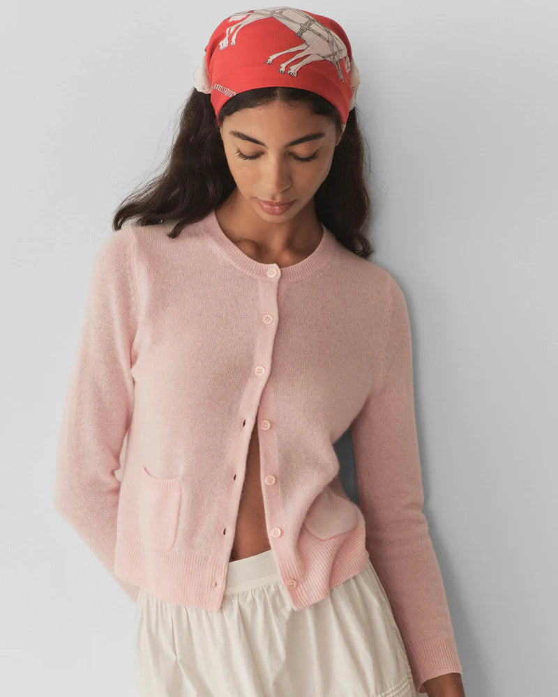 Embrace timeless elegance with the Freya Cardigan by Doen, a luxurious piece that channels 1960s sophistication. Crafted from sumptuous 100% cashmere, this fitted cardigan features a classic crew neck and bracelet-length sleeves that flatter every frame. Mother-of-pearl buttons add an understated touch of refinement, while the tailored silhouette ensures effortless polish for any occasion. 