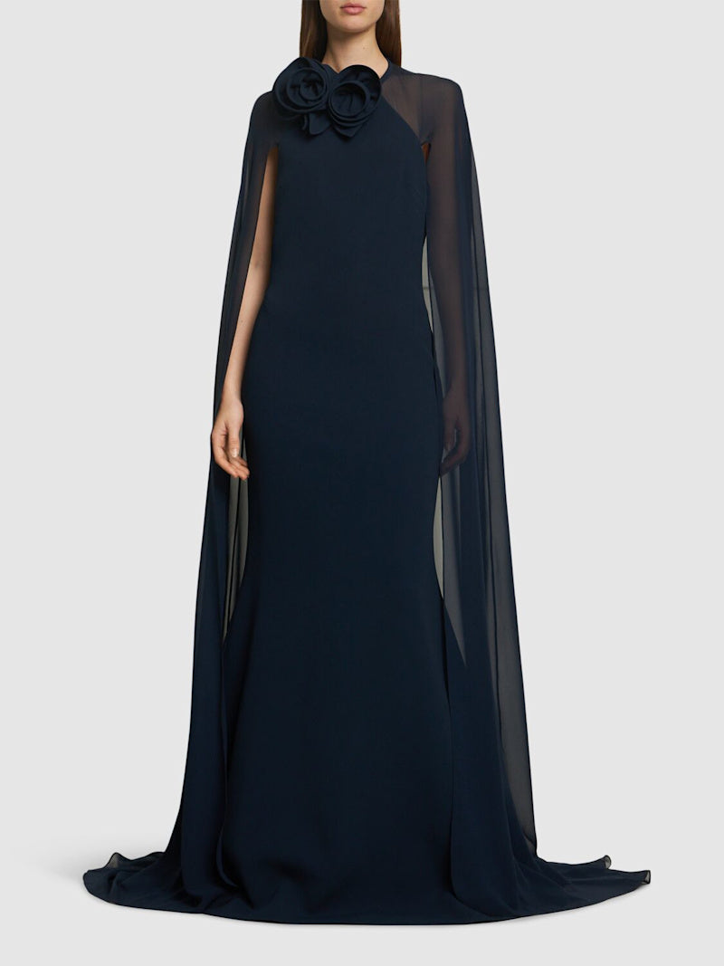The silk blend long dress by Elie Saab features a non-detachable sheer cape that adds an elegant touch to your look. The beautiful flower appliqués at the neckline give this dress a unique and feminine vibe, perfect for that special occasion. Made of a high-quality silk in a flattering navy color, this dress is available in a range of sizes to suit every body type.