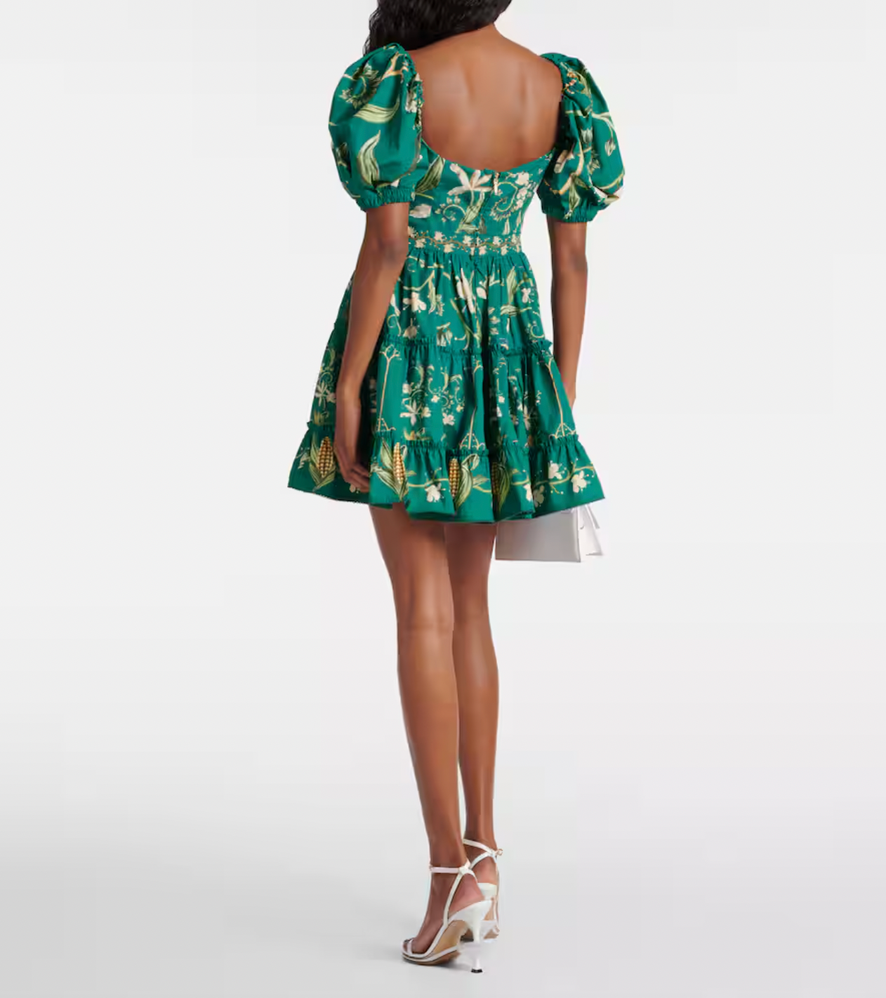 The Manzanilla Mini Dress in Neutral showcases tropical-inspired design through vibrant prints and a breezy, flattering silhouette. Made from 100% cotton poplin, it offers breathability and comfort. Key features include a deep V-neckline with an adjustable drawstring for a customized fit, short puff sleeves that add a touch of elegance, and a tiered A-line skirt that enhances movement and shape. 
