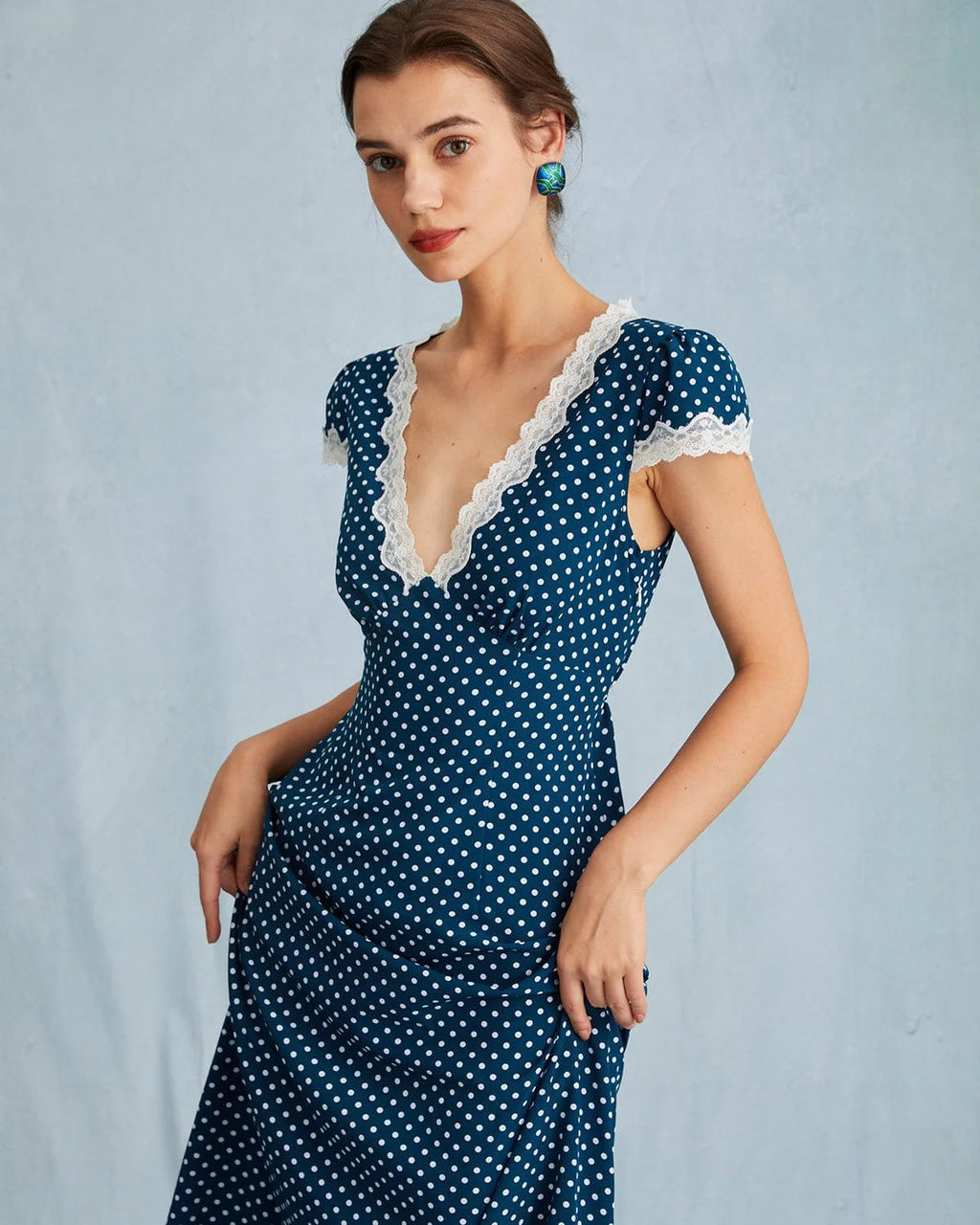Channel vintage glamour with the Clarice Dress. Made from soft polka-dot rayon, this midi dress offers a non-restrictive fit with a zip fastening and unlined design. Cap sleeves and a classic V-neck keep it elegant, while the signature bias cut and empire waist create a flattering silhouette. Style with pumps and a structured handbag for a timeless look.