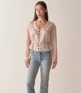 Dare to stand out in the Elayne Top from Doen, with its plunging V-neck, playful cutouts, and textured pintucks. Made with soft organic cotton, it features embroidered details, a cropped hem, and an adjustable waist tie. Take on the day with confidence and style!