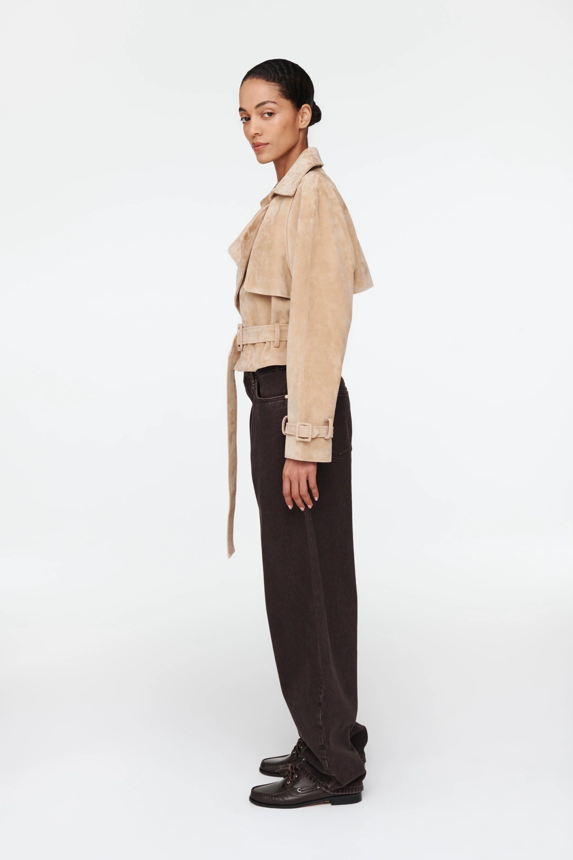 The Millie Suede Jacket by Ducie reimagines the classic trench with modern flair. This cropped silhouette features an oversized collar that commands attention, while adjustable belts at the hem and sleeves offer customizable styling and a polished finish. Effortlessly versatile, it's the ideal layer for elevating your spring and summer wardrobe with contemporary edge and timeless sophistication.