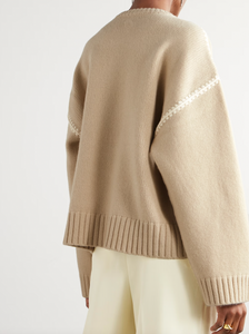 Elevate your wardrobe with this oversized sweater by Toteme crafted from a sumptuous wool and cashmere blend. Its relaxed fit with dropped shoulders offers effortless comfort, while the contrasting cream embroidery adds a refined, distinctive touch. Designed as a timeless staple, it seamlessly enriches your collection, providing both warmth and style for any occasion.