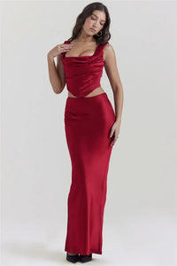 Unleash your inner glamour with our Ensemble Sydel! This elegant two piece set features a satin top with a sultry backless design and a matching long skirt, perfect for club parties. Feel confident and stylish in this crop top and skirt duo, designed to make you stand out in any crowd. Make a statement in our Ensemble Sydel!