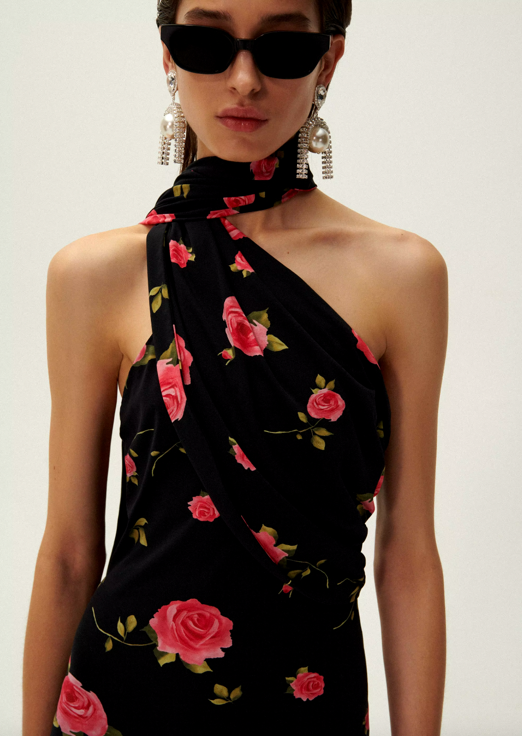 Introducing the luxurious Rose Print Jersey Long Dress by Magda Butrym. This stunning dress features a back zip closure and center back slit for ease of wear and a flattering silhouette. The non-detachable scarf panel adds a touch of elegance and the all over print placement may vary, making each dress unique. Elevate your wardrobe with this must-have piece.