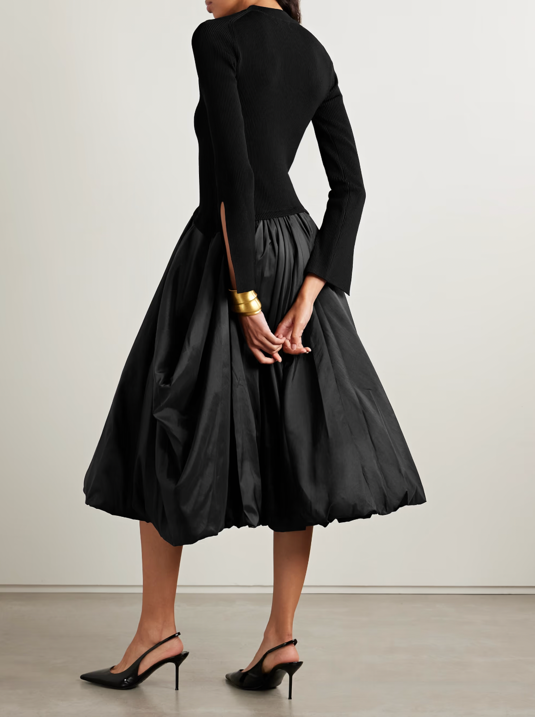 The Kenlie Ribbed-Knit and Taffeta Midi Dress by Simkhai combines a sleek, fitted bodice with a voluminous taffeta skirt that maintains its fullness thanks to soft pleats and a charming bubble hem. This elegant design offers a flattering silhouette that stays graceful whether you’re standing or sitting. Perfect for special occasions, pair it with pumps and understated jewelry to complete a sophisticated and captivating look.