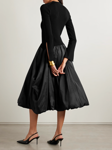 The Kenlie Ribbed-Knit and Taffeta Midi Dress by Simkhai combines a sleek, fitted bodice with a voluminous taffeta skirt that maintains its fullness thanks to soft pleats and a charming bubble hem. This elegant design offers a flattering silhouette that stays graceful whether you’re standing or sitting. Perfect for special occasions, pair it with pumps and understated jewelry to complete a sophisticated and captivating look.