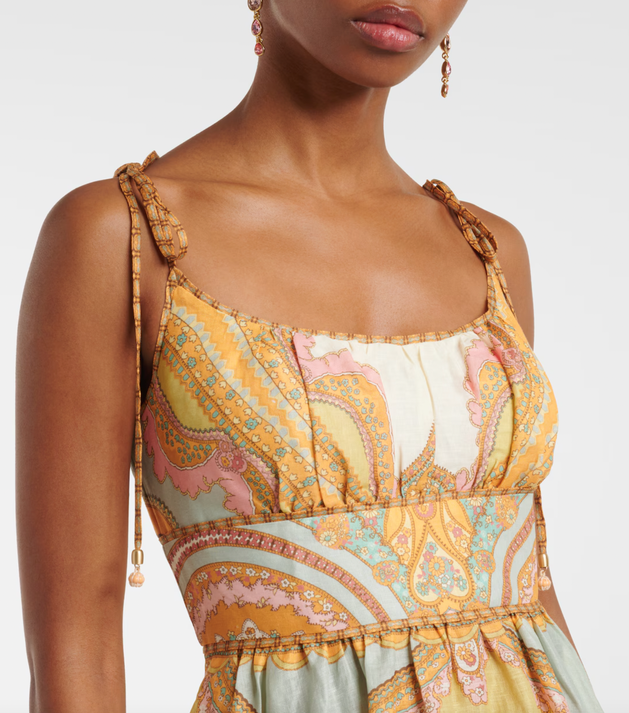 Elevate your wardrobe with the Maxine Picnic paisley linen bustier dress from Zimmermann. This midi-length dress showcases a timeless paisley placement print on breathable linen, highlighting a fitted bustier with delicate gathering and flat piping for a flattering silhouette. Self-tie straps offer adjustable comfort, while side seam pockets add practical charm. Perfect for warm days and stylish gatherings, this dress effortlessly combines elegance and ease.