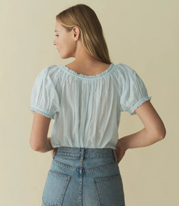 Rendered in 100% organic cotton voile, the Frederica Top features a breezy silhouette, a round neckline, and short puffed sleeves adorned with scalloped lace. Alternating pintuck clusters, lace, and delicate floral embroidery decorate the front. Leave it loose, or tuck it into your favorite pair of high-waisted jeans.