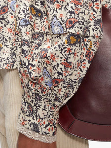 Step into the free-spirited 70s with the Reign Ruffled Paisley-Print Blouse! Adopted by icons like Janis Joplin and Jimi Hendrix, this Isabel Marant Étoile blouse exudes bohemian charm with its multicoloured paisley pattern. Lightweight poplin and delicate lace-trimmed ruffles add a feminine touch. Pair with tailored trousers for a stylish contrast.
