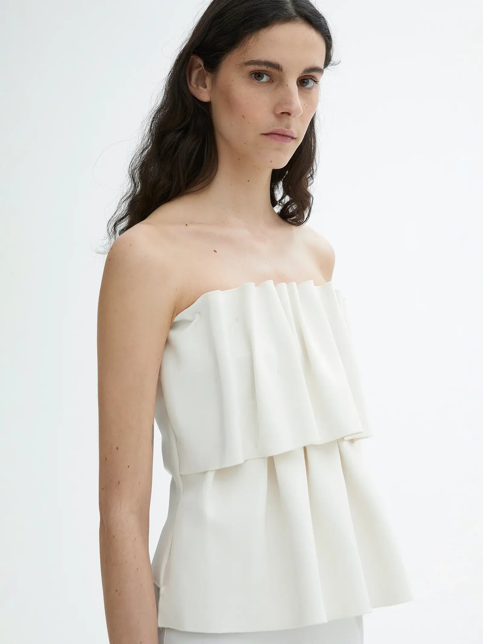 Introducing the Sculpted Tube Top by House of Dagmar - the perfect blend of elegance and sustainability! This sleeveless top features a sculpted, figure-hugging fit and a draped design, making it the ideal choice for dressier occasions. Add a touch of style and conscience to your wardrobe with this must-have top.