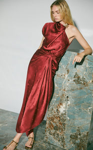 Elevate your style with the Warrior Tradition Draped Silk Maxi Dress by Johanna Ortiz. The slim fit, draped neckline, and one-shoulder design add a touch of sophistication, while the knotted waist and metallic knot pen create a chic silhouette. The dotted texture and midi hem add a touch of elegance to this lined dress.