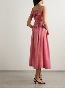 Elevate your wardrobe with DOEN's Emmaretta Shirred Gingham Midi Dress. Made from luxurious organic cotton-voile, it boasts vibrant gingham checks and a shirred bodice with slim, adjustable ties for a flattering fit. Complete with playful ruffled straps and a floaty skirt, this dress is the perfect blend of femininity and elegance.