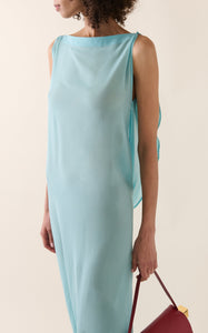 Experience the ethereal elegance of the Ameno dress by Jacquemus, crafted from light-as-air silk chiffon that drapes effortlessly along your back. Its flowing train mirrors the gentle movement of water, creating a captivating silhouette that turns every step into a statement of grace. Elevate your wardrobe with this stunning design that promises both beauty and fluidity.