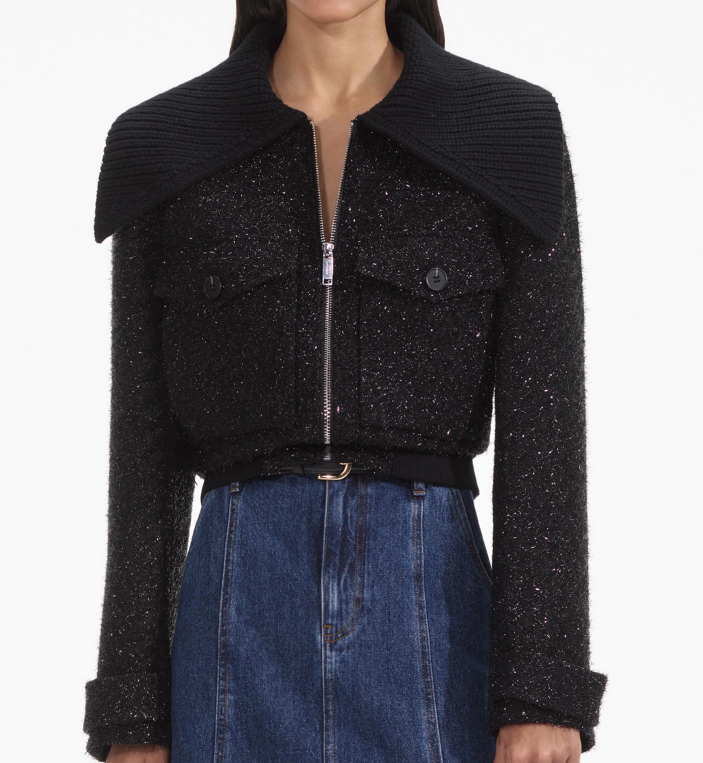 Indulge in opulence with the Tinsel Boucle Jacket. Drenched in black tinsel boucle, it boasts a cinched silhouette and elasticated waist. The perfect party piece, its oversized knitted collar pairs beautifully with our statement earrings. With a true-to-size fit and functional pockets, it's both chic and practical.