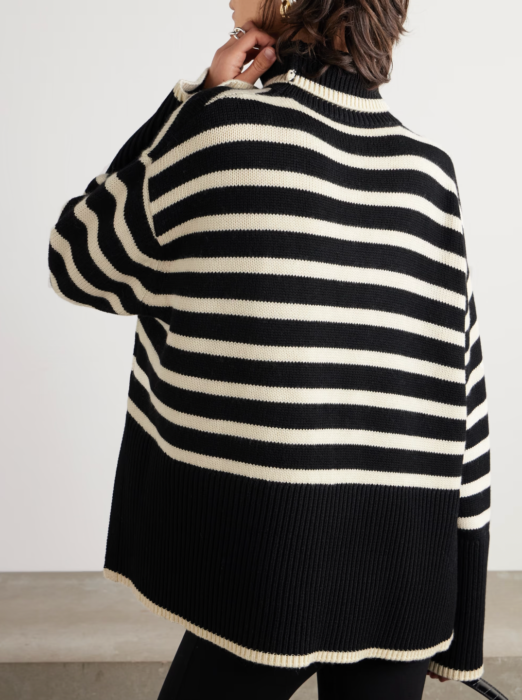 This striped wool-blend turtleneck sweater from TOTEME combines timeless style with cozy comfort. Crafted from a soft blend of wool and organic cotton, it features a relaxed fit and a classic turtleneck, making it perfect for layering. The iconic stripes add a refined touch, while the breathable fabric ensures warmth without bulk. Pair it with tailored pants for an effortlessly polished look that lasts season after season.